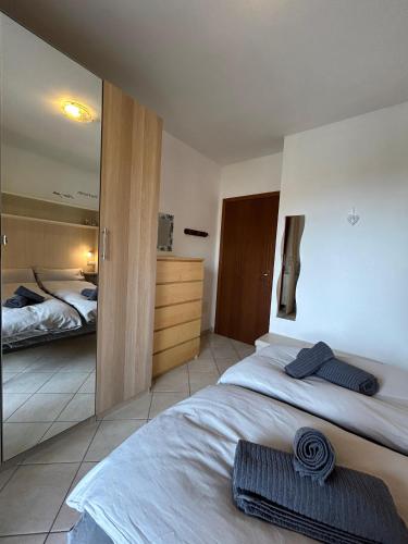 a bedroom with two beds and a mirror at Apartment Cristina - Tignale Lake Garda in Tignale