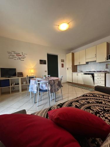 a living room with a table and a kitchen at Apartment Cristina - Tignale Lake Garda in Tignale