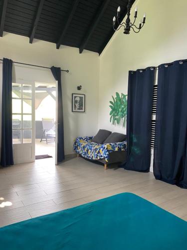 a bedroom with a bed and a sliding glass door at Blue dream Bungalow in Le Gosier