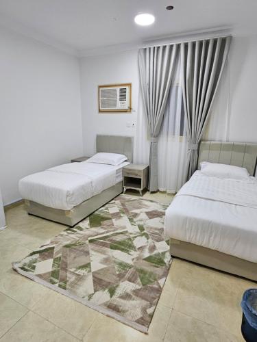 En eller flere senge i et værelse på شقق مفروشة