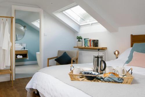 a bedroom with a bed with a basket on the bed at Luxury Devon Hayloft with panoramic Dartmoor views in Ilsington