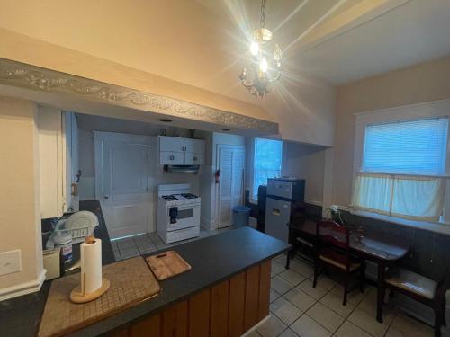 a kitchen with a counter top and a dining room at Best Rooming Houses in Rocky Mount NC. in Rocky Mount