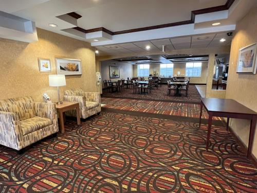 a lobby with couches chairs and tables in a hotel at Quality Suites Midland North Loop 250 in Midland