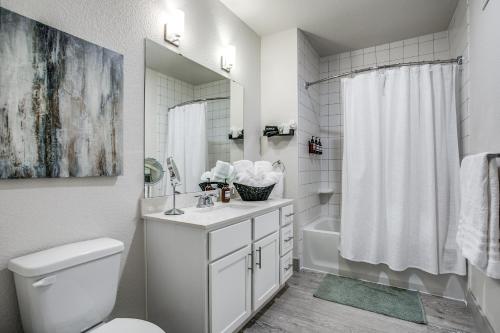 a white bathroom with a sink and a toilet at Modern Luxury Condo on Riverwalk #1335 in San Antonio