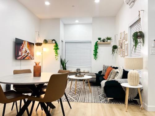 a living room with a table and chairs and a couch at Modern 3BR Oasis Free Parking in Oakland
