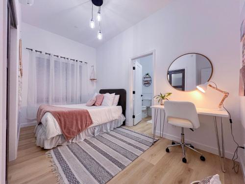 a bedroom with a bed and a desk and a mirror at Modern 3BR Oasis Free Parking in Oakland