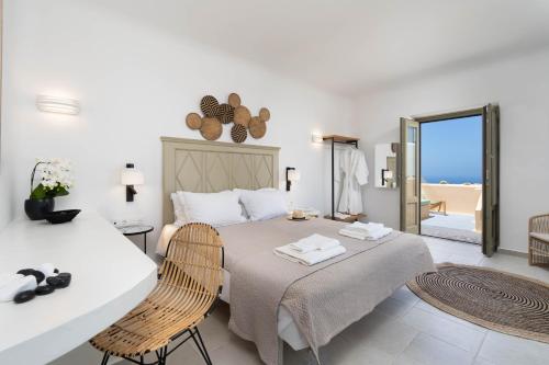 A bed or beds in a room at Santorini Hillside Suites & Villas