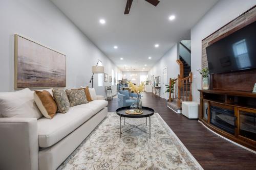 a living room with a white couch and a tv at Charming Indianapolis Home~5 Min to Lucas Oil in Indianapolis