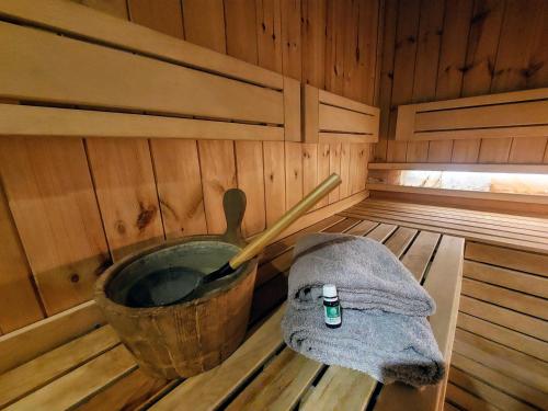 an inside of a sauna with a bucket and a towel at Vila MP Banstol 4*- Brdež do, Fruška gora in Inđija