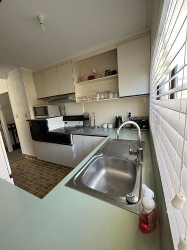 a kitchen with a stainless steel sink in a kitchen at T Two on Whakaue in Rotorua