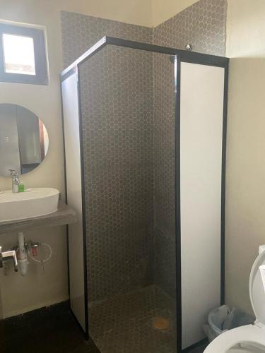 a bathroom with a shower with a toilet and a sink at REGMAR Progreso Yucatán in Progreso