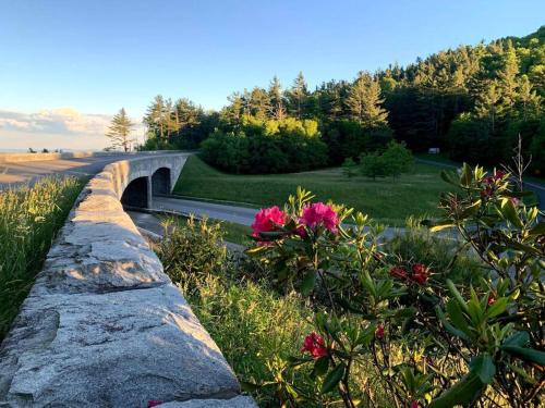 a stone wall next to a road with a bridge at Downtown Boone ON King Street - 2 Bedroom Home in Boone
