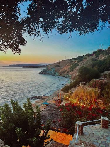 a view of a beach with a body of water at Aneroussa Beach Hotel in Batsi