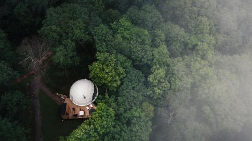 an aerial view of a water tower in the forest at Dômes Charlevoix in Petite-Rivière-Saint-François
