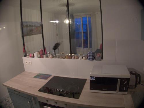 a kitchen with a counter with a toaster and a microwave at Beauty of Paris in Paris