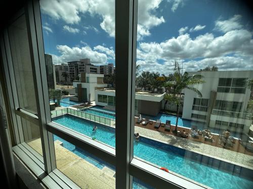 a view of a swimming pool from a window at Flat no Jade in Brasilia