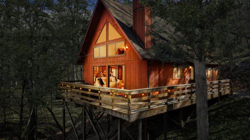 a cabin in the woods with a tree at Chalet w Huge Deck, Grill, WiFi, Mins to Bryce! in Basye