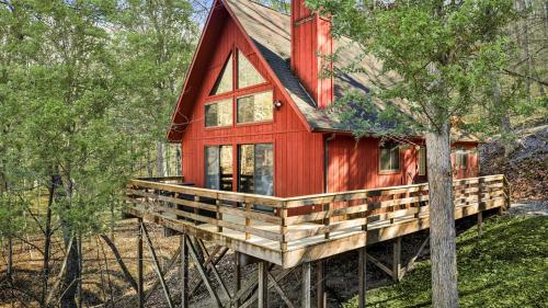 a red cabin in the woods with a tree at Chalet w Huge Deck, Grill, WiFi, Mins to Bryce! in Basye