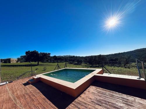 a swimming pool sitting on top of a wooden deck at LOS PINOS DE NAVALFRESNO in Aracena