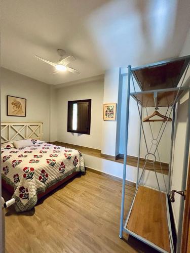 a bedroom with a bed and a shelf in it at LOS PINOS DE NAVALFRESNO in Aracena