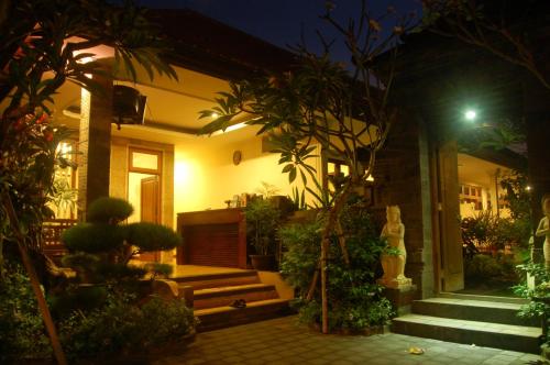 a house at night with a bunch of plants at Gunakaya Homestay in Sanur