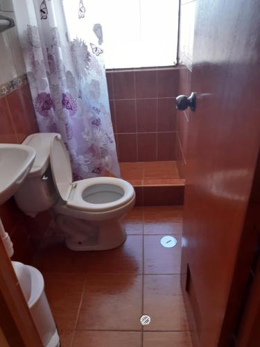 a bathroom with a toilet and a sink at Hostal Vista al Lago Titicaca Puno in Puno