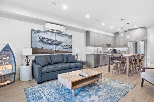 a living room with a couch and a table at Seas The Day Saratoga at THE BEACH HOUSE in Campbell River