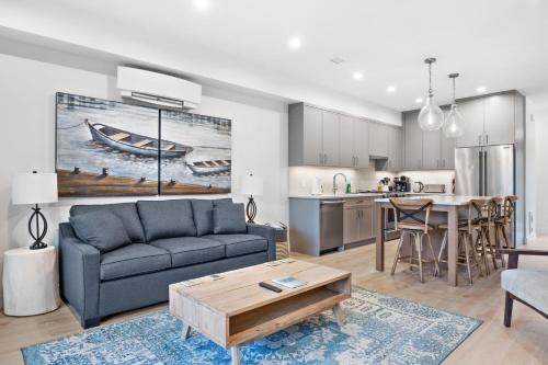 a living room with a couch and a table at Seas The Day Saratoga at THE BEACH HOUSE in Campbell River