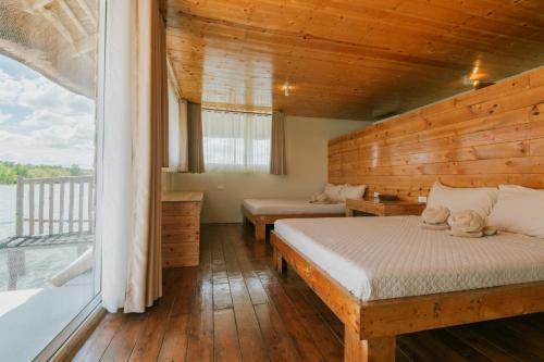 a bedroom with a bed and a large window at Kaway Resort & Spa in Tabuelan