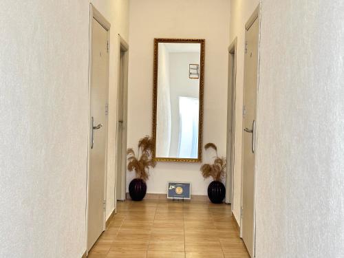 a hallway with a large mirror and a floor at Apartments Pribilovic in Budva