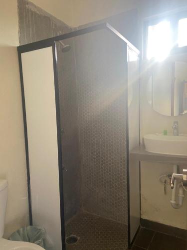 a bathroom with a shower and a sink at REGMAR Progreso Yucatán in Progreso