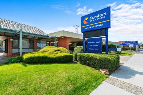 a sign in front of a building with bushes at Comfort Inn & Suites Lakes Entrance in Lakes Entrance