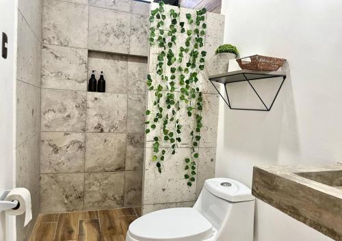 a bathroom with a toilet and a shower curtain at Departamento climatizado excelente ubicación in Veracruz