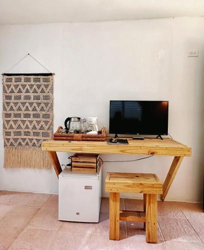 a wooden desk with a computer on top of it at Hacienda Verde Luz 