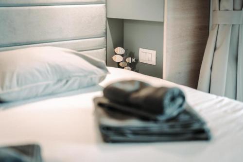 a black purse sitting on top of a bed at SEA HOUSE pool & jacuzzi, bikes, SUP - PRIVILEGE POINT camping & villas in Selce