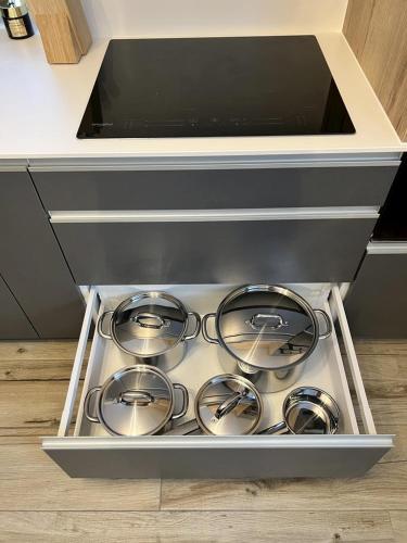 a drawer in a kitchen with a bunch of burners at Chata pod Starou Horou in Trstená