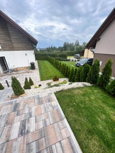 a backyard with a lawn and a yard with trees at Chata pod Starou Horou in Trstená