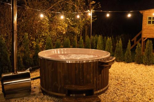a large wooden tub in a garden at night at Chata pod Starou Horou in Trstená