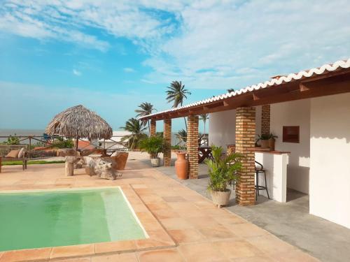 a villa with a swimming pool and a patio at Pousada Makai - Cajueiro da Praia in Barra Grande