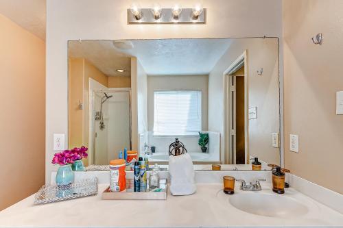 a bathroom with a sink and a large mirror at Houston Blue House in Houston