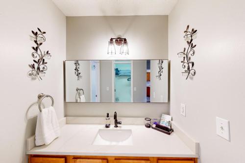 a bathroom with a sink and a mirror at Amazon Riviera in Foley