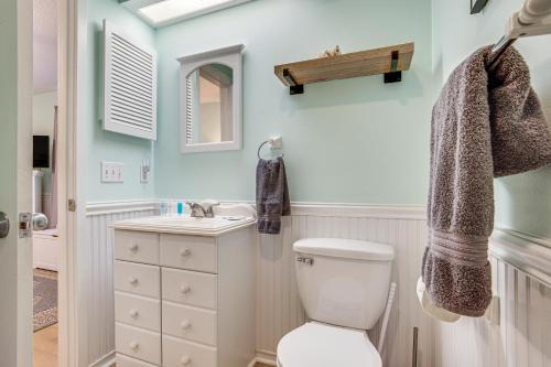 a bathroom with a toilet and a sink at Saint Helena Island Condo - Steps to Beach! in Oceanmarsh Subdivision