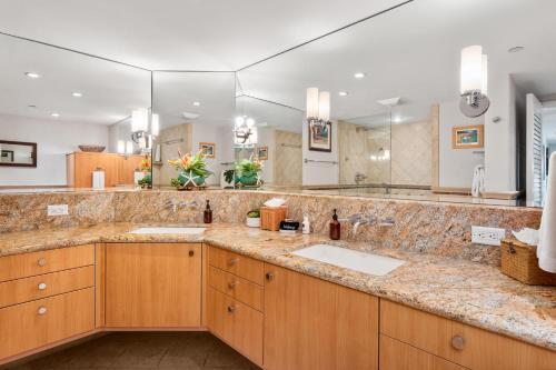 a bathroom with two sinks and a large mirror at Kaanapali Alii 255 in Lahaina
