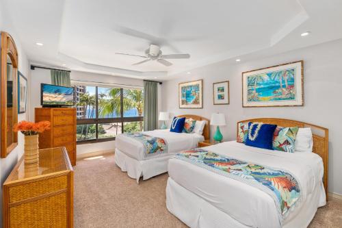 a bedroom with two beds and a window at Kaanapali Alii 255 in Lahaina