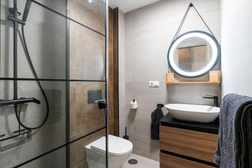 a bathroom with a toilet and a sink and a mirror at 2 bedrooms apartement with wifi at Sevilla in Seville