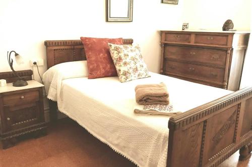 a bedroom with a wooden bed with two pillows at 5 bedrooms chalet with terrace and wifi at Parada in Portas