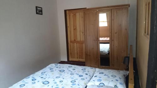 a small bedroom with a bed and a window at Chalupa U Potoka in Staré Hory