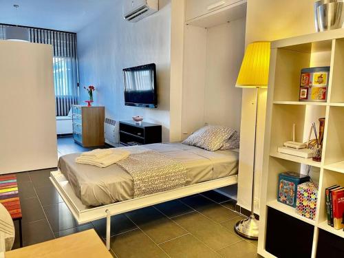 a bedroom with a bed and a tv in it at One bedroom appartement at Torremolinos 900 m away from the beach with wifi in Torremolinos