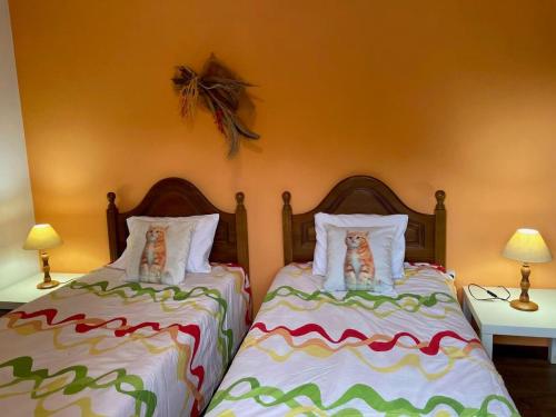 two beds sitting next to each other in a bedroom at 2 bedrooms house with shared pool enclosed garden and wifi at Ponte de Lima in Ponte de Lima