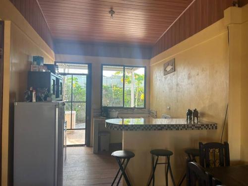 a kitchen with a counter and some stools in it at Casa Sendero in Liberia